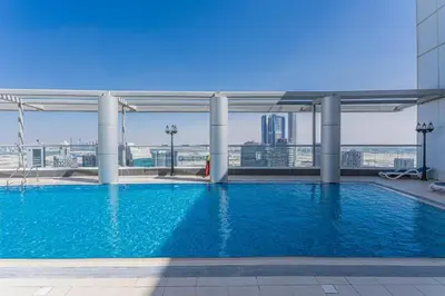 a swimming pool on the roof of a building at Downtown Dubai Mall walk & Burj Khalifa DIFC 5 mins in Dubai