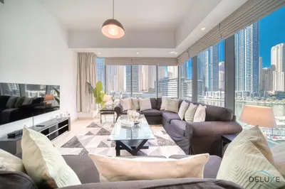 a living room with a couch and a table at Beautiful 2BR at Silverene Towers A Dubai Marina by Deluxe Holiday Homes in Dubai