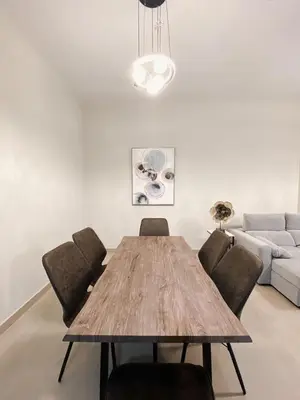 a dining room table with chairs and a couch at Luxurious & Modern 2BR Plus Maid, Sparkle Tower Dubai Marina - 10AB4 in Dubai