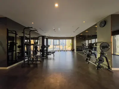 a gym with several treadmills and elliptical machines at Experience Opulent Living at Paramount Midtown in Dubai
