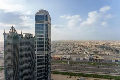 a view of a tall skyscraper in a city at Experience Opulent Living at Paramount Midtown in Dubai