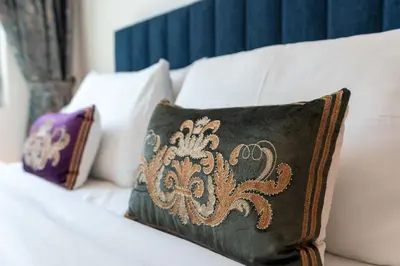 a pillow sitting on a white couch with at Lux BnB I Una Tower I Lakes View in Dubai