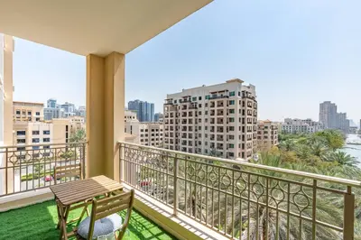 a balcony with a bench and a view of the city at Lux BnB I Una Tower I Lakes View in Dubai