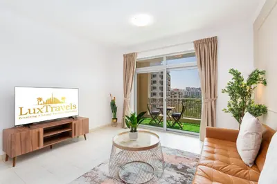a living room with a couch and a large window at Lux BnB I Una Tower I Lakes View in Dubai
