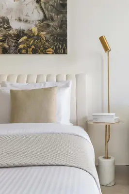 a bedroom with a bed with a painting on the wall at Frank Porter - Riviera 26 in Dubai