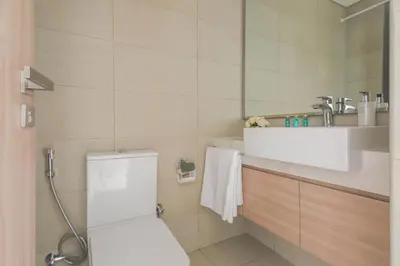 a bathroom with a toilet and a sink at Frank Porter - Riviera 26 in Dubai