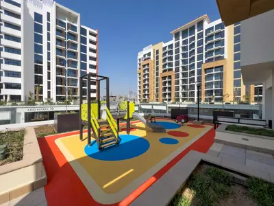 a playground on a roof with tall buildings at Frank Porter - Riviera 26 in Dubai
