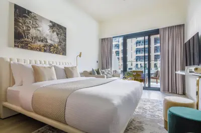 a bedroom with a large bed and a large window at Frank Porter - Riviera 26 in Dubai