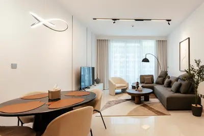 a living room with a table and a couch at Luxurious Waterfront 1BR with Stunning Sea Views - 15AB02 in Dubai