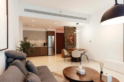 a living room with a couch and a table at Luxurious Waterfront 1BR with Stunning Sea Views - 15AB02 in Dubai