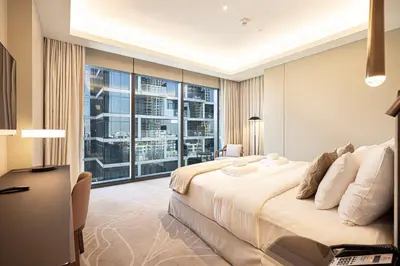 a bedroom with a large bed and a large window at SmartStay at Address Opera - Unique Burj Khalifa Views - Brand New Luxury Residences in Dubai