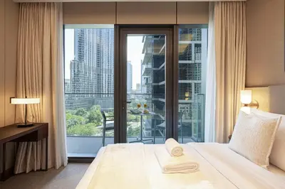 a hotel room with a bed and a large window at SmartStay at Address Opera - Unique Burj Khalifa Views - Brand New Luxury Residences in Dubai