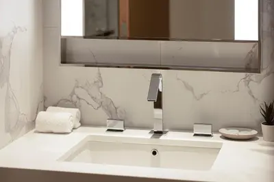 a white sink in a bathroom with a mirror at SmartStay at Address Opera - Unique Burj Khalifa Views - Brand New Luxury Residences in Dubai