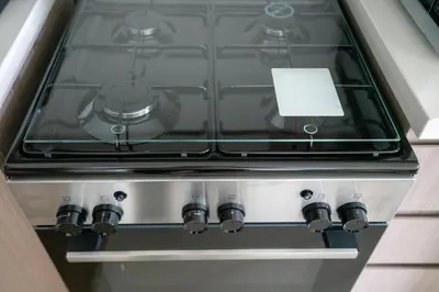 a stove top oven sitting inside of a kitchen at Mystic - Act One Tower in Dubai