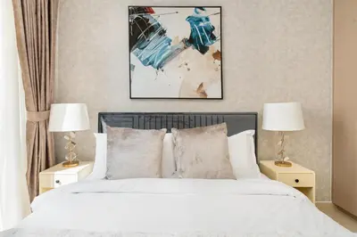 a bedroom with a white bed and two lamps at Mystic - Act One Tower in Dubai