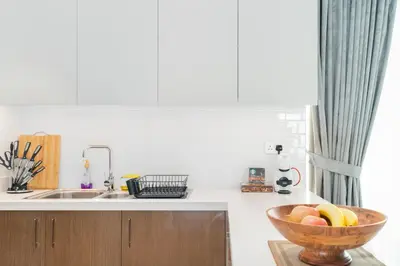 a kitchen with a bowl of fruit on a counter at Mystic - Forte Tower 2 in Dubai