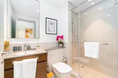 a bathroom with a shower and a toilet and a sink at Mystic - Forte Tower 2 in Dubai