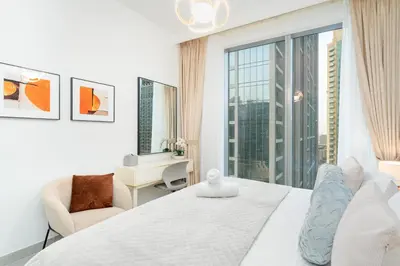 a bedroom with a white bed and a large window at Mystic - Forte Tower 2 in Dubai