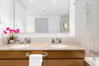 a bathroom with two sinks and a shower at Mystic - Forte Tower 2 in Dubai