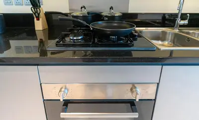 a frying pan sitting on top of a stove in a kitchen at Mystic - Damac Maison Prive Tower B in Dubai