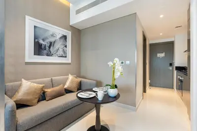 a living room with a couch and a table at Mystic - Damac Maison Prive Tower A in Dubai
