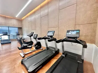 a gym with several treadmills and a treadmill at Luxury Studio in High Floor Full Sea View in The Palm Tower Plam Jumeirah in Dubai