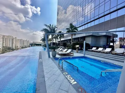 a large swimming pool on the side of a building at Luxury Studio in High Floor Full Sea View in The Palm Tower Plam Jumeirah in Dubai