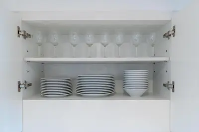 a shelf with plates and wine glasses on it at Burj Khalifa & Dubai Dancing Fountain View, 54th Floor & Dubai Mall Access in Dubai