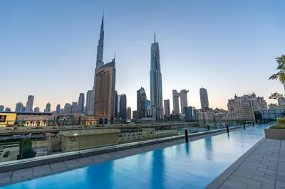 a view of a city skyline with a river at Burj Khalifa & Dubai Dancing Fountain View, 54th Floor & Dubai Mall Access in Dubai
