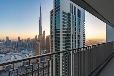 a view of a city from the balcony of a skyscraper at Burj Khalifa & Dubai Dancing Fountain View, 54th Floor & Dubai Mall Access in Dubai