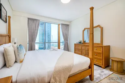 a bedroom with a large bed and a large window at Sophisticated 3BR w/ Assistant’s Room at Al Fattan Marine Towers 2 JBR by Deluxe Holiday Homes in Dubai
