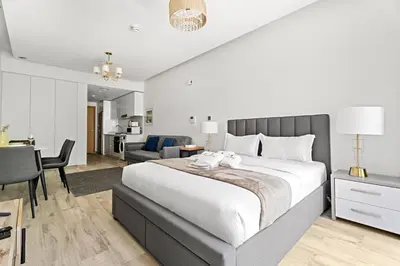 a bedroom with a large bed and a living room at StoneTree - Modern Studio - Special Offer! in Dubai
