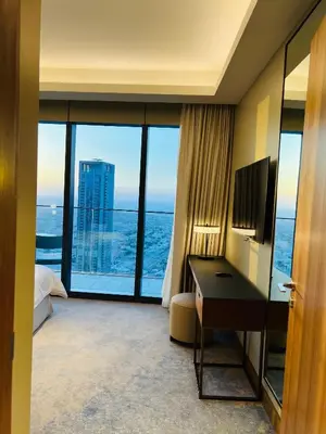 a hotel room with a desk and a view of the ocean at The Address Residences Dubai Opera in Dubai