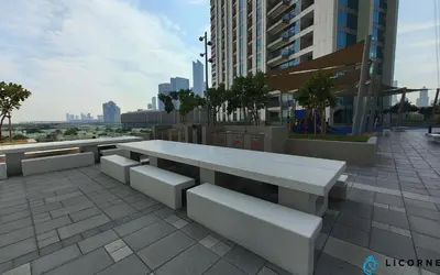 a white bench on a sidewalk in a city at Unveil Downtown Luxury, 1BR Majestic Skyline Views - Downtown Views ll in Dubai
