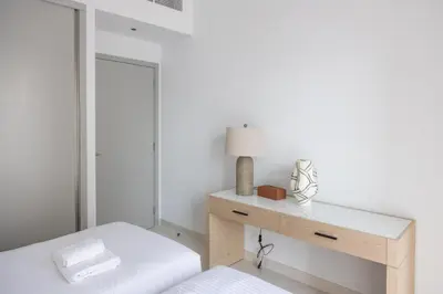 a bedroom with a dressing table and a mirror at Beachfront Elegant 2BD Condo with Breathtaking Views -15AB01 in Dubai