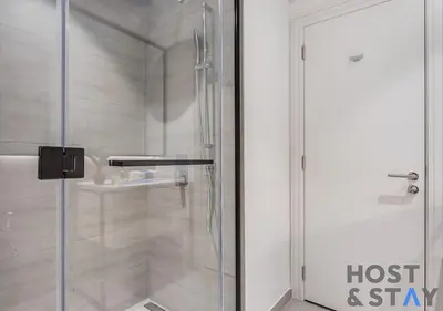 a shower with a glass door in a bathroom at Luxury Studio at Wilton Park - MBR in Dubai