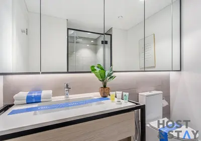 a bathroom with a large white sink with a mirror at Luxury Studio at Wilton Park - MBR in Dubai