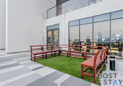 a balcony with two benches and green grass at Luxury Studio at Wilton Park - MBR in Dubai