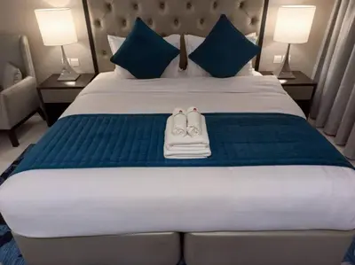 a pair of shoes sitting on top of a bed at StoneTree - Furnished Studio - Celestia B in Dubai