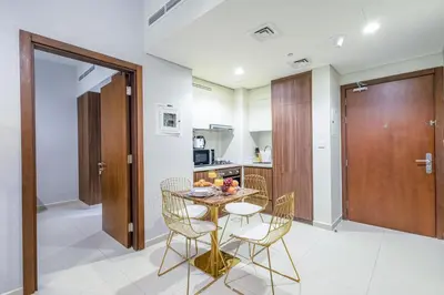 a kitchen with a table and chairs in a room at TruStay Vacation Home Rentals - Business Bay in Dubai