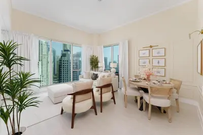a white living room with a table and chairs at Maison Privee - Modern Beach Living in the Heart of Dubai Marina in Dubai