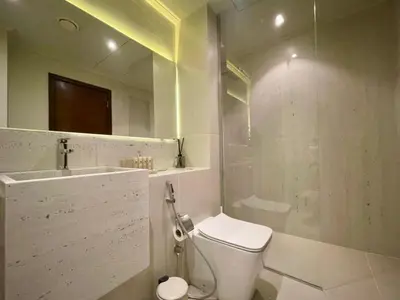 a bathroom with a toilet and a sink and a shower at Maison Privee - Modern Beach Living in the Heart of Dubai Marina in Dubai