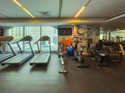 a gym with a bunch of treadms and machines at Maison Privee - Modern Beach Living in the Heart of Dubai Marina in Dubai
