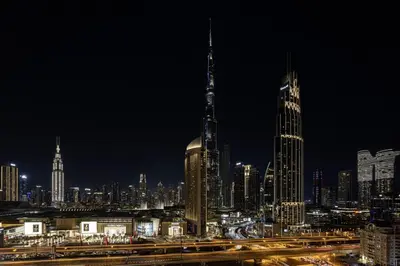 a view of a city at night with traffic at Downtown - Burj Khalifa Facing - 2 Bed Luxe Apartment in Dubai