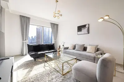 a living room with a couch and a table at Downtown - Burj Khalifa Facing - 2 Bed Luxe Apartment in Dubai