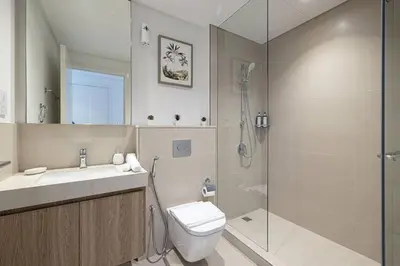 a bathroom with a toilet and a sink and a shower at Downtown - Burj Khalifa Facing - 2 Bed Luxe Apartment in Dubai