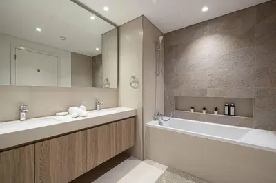 a bathroom with a tub and a sink and a bath tub at Downtown - Burj Khalifa Facing - 2 Bed Luxe Apartment in Dubai