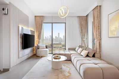 a living room with a couch and a tv at Burj Khalifa View Lux concierge in Dubai