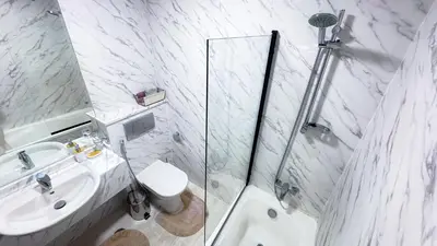 a bathroom with a toilet and a sink and a shower at Dubai Marina - Modern Designed - Gorgeous Studio- Close Metro Station in Dubai