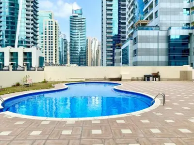 a swimming pool in a city with tall buildings at Dubai Marina - Modern Designed - Gorgeous Studio- Close Metro Station in Dubai
